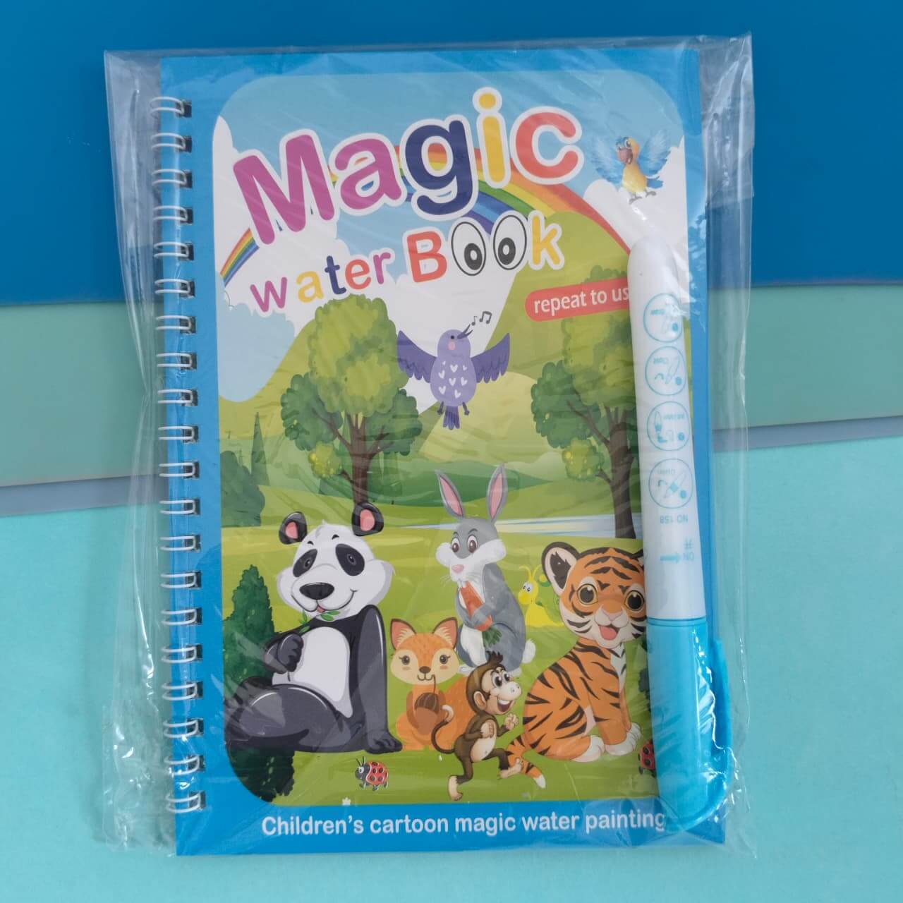 Children's magic water book with cartoon animals and a pen on a blue background